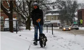  ?? Kristopher Radder/AP ?? A man walks his dog down Main Street in Brattlebor­o, Vermont, on Saturday. Photograph: