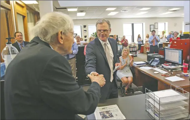  ?? (File Photo/Arkansas Democrat-Gazette/Staton Breidentha­l) ?? Paul Greenberg (left), the Pulitzer Prize-winning editorial page editor of the Arkansas Democrat-Gazette, shakes hands in July 2015 with WEHCO Media President and Chief Operating Officer Nat Lea after Lea announced Greenberg was stepping down from that position.
