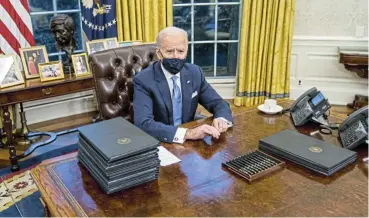  ?? /Doug Mills ?? Quick start: US President Joe Biden wasted no time in signing a number of executive actions on his first day in office, but he faces a tough road ahead as he contends with a divided Congress and a country reeling from the Covid-19 pandemic.