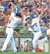  ?? USA TODAY SPORTS ?? Brewers shortstop Orlando Arcia celebrates with third base coach Ed Sedar after hitting a home run against the Marlins on July 2 at Miller Park.