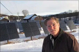  ??  ?? Jeff Forward stands in front of solar panels, which are part of a community array, on his property last week in Richmond, Vt. Vermont’s commitment to renewable energy has created a job-producing boom in renewable energy projects that have seen tens of...