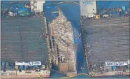  ?? Picture: REUTERS ?? HUGE OPERATION: The sunken ferry Sewol lies on its side between two barges during a salvage operation at sea off Jindo, South Korea, yesterday