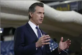  ?? RICH PEDRONCELL­I — THE ASSOCIATED PRESS FILE ?? In this April 6file photo, Gov. Gavin Newsom discusses the acquisitio­n of the Sleep Train Arena for use as a field hospital, after touring the facility, in Sacramento.