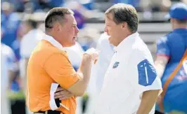  ?? AP FILE ?? Coach Jim McElwain, right, is hoping for a UF win today to restore the confidence of a young team, calm an agitated fan base and avoid the program’s first 0-2 start since 1971.