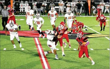  ?? MARK HUMPHREY ENTERPRISE-LEADER ?? Farmington freshman tailback Landyn Faught turns the corner while carrying the football for a gain against Southwest Junior High, of Springdale, on Thursday, Oct. 17. The junior Cardinals defeated Southwest, 20-0, with Faught scoring twice on rushing touchdowns of 20 and 5 yards.