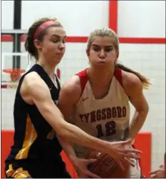  ?? (JULIA MALAKIE/LOWELL SUN ?? Littleton’s Kaylin O’meara, left, defends against Tyngsboro’s Carly Dimento on Friday. Littleton earned a 46-37state tournament victory.