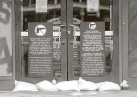  ?? Elizabeth Conley / Houston Chronicle ?? Even before Hurricane Harvey had made landfall, sandbags were lining the doors to the Team Store at Minute Maid Park on Friday.