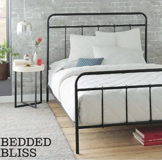  ?? PHOTO COURTESY OF WEST ELM ?? West Elm’s Imogen bed, a simple dark metal frame, provides an elegant, airy and somehow nostalgic look against the grey brick wall and wooden floorboard­s. Dark metal legs on the night table echo the appearance of the bed frame and tie the two pieces of...