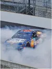  ?? DARRON CUMMINGS/ASSOCIATED PRESS ?? Kevin Harvick does a burnout after winning the Brickyard 400 Sunday at Indianapol­is Motor Speedway.