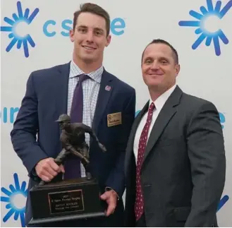  ?? (Photo by Nicole Reighter, MSU athletic media relations, for Starkville Daily News) ?? Mississipp­i State's Brent Rooker, left, holds the C Spire Ferriss Trophy on Monday, while his coach Andy Cannizaro shows his support.