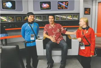  ?? AP PHOTO ?? In this Aug. 13 photo, Keith Schubert of Peru, N.Y., left, dressed as Star Trek’s Mr. Spock, and his daughter Tiffany Schubert, right, talk with James Cawley, center, during a tour of his replica of the starship Enterprise from the original Star Trek...