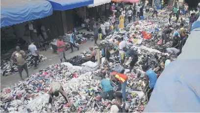 ?? Pictures: AFP ?? HIVE OF ACTIVITY. Traders spread out second-hand clothes for sale at the Kantamanto market in Accra, Ghana.