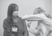  ?? JOSEPH PREZIOSO/GETTY-AFP ?? Pharmacist Madeline Acquilano inoculates Lynette Rodriguez with the Johnson& Johnson COVID-19 vaccine March 3 at Hartford Hospital.