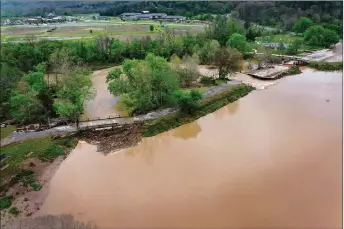  ?? File Photo/NWA Democrat-Gazette/Spencer Tirey ?? A section of the dam that creates Lake Bella Vista is seen washed away April 29, 2021.