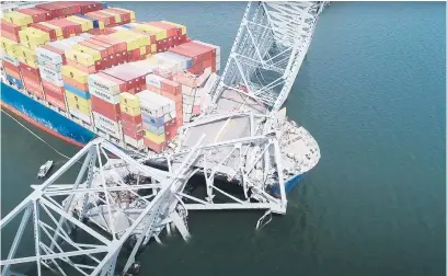  ?? Picture: AFP ?? BRIDGE TOO FAR. Part of the steel frame of the Francis Scott Key Bridge sits on top of the container ship, Dali, after the bridge collapsed in Baltimore, Maryland, on Tuesday.