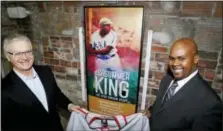  ?? KEITH SRAKOCIC — THE ASSOCIATED PRESS ?? The Executive Director of the Josh Gibson Foundation, right, holds a replica Pittsburgh Crawfords jersey with Pittsburgh Opera General Director Christophe­r Hahn as they pose next to a poster at the Pittsburgh Opera House in Pittsburgh.