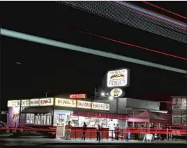  ?? Luis Sinco Los Angeles Times ?? AFTER a two-month shutdown, Pink’s Hot Dogs reopened Monday. Like many businesses in the Melrose Avenue shopping area, the eatery has seen revenue fall.