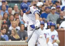  ?? | JONATHAN DANIEL/GETTY IMAGES ?? Kris Bryant smacks a run-scoring double in the first inning Thursday night off Chris Sale at Wrigley Field.