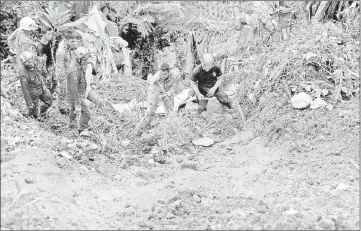  ??  ?? Rescuers look for farm workers believed to have been buried by a landslide in Cameron Highlands on Nov 6. Higher rainfall inputs due to climate change could increase the chances of landslides. — File photo