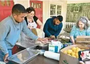  ?? RON SCHLOERB/CAPE COD TIMES ?? Volunteers prepare food Thursday for Venezuelan migrants who were flown to Martha’s Vineyard in Massachuse­tts from San Antonio the day before.