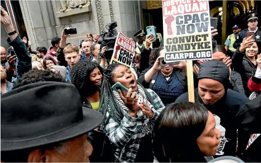  ?? AP ?? People react outside of City Hall after a jury convicted white Chicago police Officer Jason Van Dyke of second-degree murder in the 2014 shooting of black teenager Laquan McDonald.