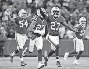  ?? [AP PHOTO] ?? Buffalo Bills cornerback Tre’Davious White (27) reacts after his intercepti­on against the Miami Dolphins on Sunday. White and the Bills meet New England Sunday and there could be some bad blood after the Patriots’ Rob Gronkowski’s blind side hit on...