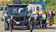  ?? AP ?? CITY ON THE EDGE: Police officers in action following the shooting in Fredericto­n, Canada, on Friday. —