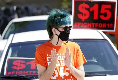  ?? John Raoux/Associated Press ?? McDonald’s employee Cristian Cardona attends a rally in support of a $15-an-hour minimum wage Tuesday in Orlando, Fla.