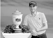  ?? GREGORY SHAMUS/GETTY IMAGES ?? Justin Thomas poses with the Gary Player Cup after winning the WGC Bridgeston­e Invitation­al by 4 shots.