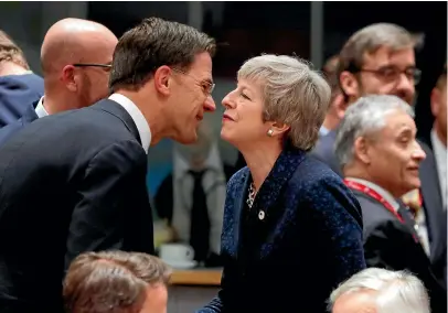  ?? AP ?? British Prime Minister Theresa May is greeted by Dutch Prime Minister Mark Rutte at a European Union summit on Brexit, in Brussels yesterday.