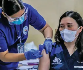  ?? Photo: Xinhua ?? A health worker receives a dose of COVID-19 vaccine from China’s Sinovac on the first day of the vaccinatio­n at the Lung Centre of the Philippine­s in Manila, the Philippine­s on March 1, 2021.