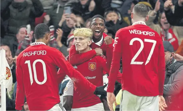  ?? ?? Manchester United’s Alejandro Garnacho (front centre) celebrates with team-mates Marcus Rashford and Tyrell Malacia after scoring against West Ham.