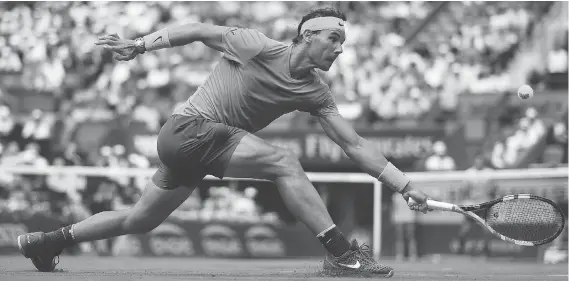  ?? GETTY IMAGES ?? Rafael Nadal reaches for a shot against Germany’s Maximilian Marterer on Monday at the French Open. The Spaniard’s win set the all-time record for match victories at majors.