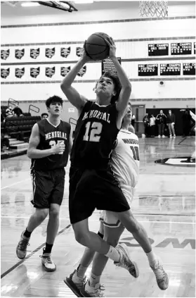  ?? Photos by John Zwez ?? Above left, Brandon Bowers of St. Marys goes up for a shot during the first half of Wednesday’s playoff game with Wauseon. Above right, Austin Parks draws contact from Wauseon’s Easton Delgado.