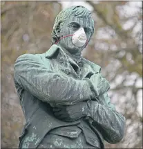  ??  ?? A statue of Scotland’s worldfamou­s Bard with face mask in Vancouver, Canada