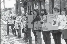  ?? MITCH MACDONALD/THE GUARDIAN ?? A group holds placards outside of Island Activewear on University Avenue while protesting against Canada Goose’s use of coyote fur and goose down in their jackets in this February 2018 Guardian file photo. Wood said the group was one of about 16 throughout Canada participat­ing in national Anti-Fur Day.