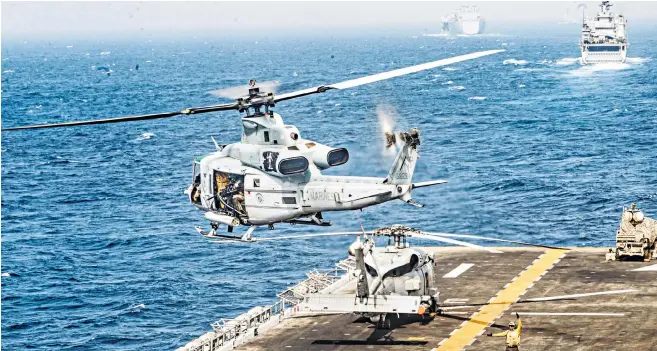  ??  ?? Helicopter­s and marines protect USS Boxer, above. The amphibious assault ship was reportedly approached by an Iranian surveillan­ce drone which it brought down with electronic jamming equipment. Inset left, the seized British oil tanker Stena Impero