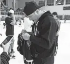  ??  ?? Recently traded Blue Jackets winger Cam Atkinson signs a fan’s jersey at the Ohiohealth Ice Haus on Saturday.