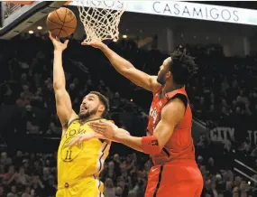  ?? Steve Dykes / Associated Press ?? Warriors guard Klay Thompson drives on Trail Blazers guard Evan Turner in the first half. Thompson scored 32 points, his second highest total this season.