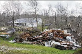  ?? VASHA HUNT / AP ?? Debris litters weather-damaged properties at the intersecti­on of County Road 24 and 37 in Clanton, Ala., on Thursday, the morning after a large outbreak of severe storms across the southeast.