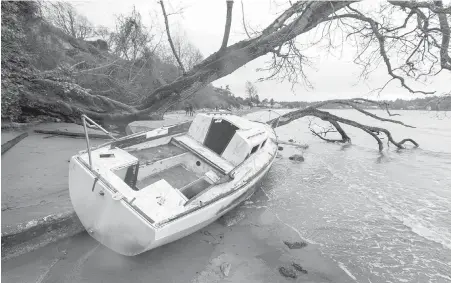  ??  ?? Derelict boats, like this one that washed up at Cadboro Bay in February, have been a thorn in the side of the capital region for years.