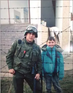  ?? JUSTIN FRYE/The Canadian Press ?? Justin Frye, left, poses with Amir Bagramovic, a Bosnian child he met while stationed in the war-torn country with the United Nations in 1994 in this handout photo. The Canadian veteran of the Bosnian war who reconnecte­d with a local boy he met during...