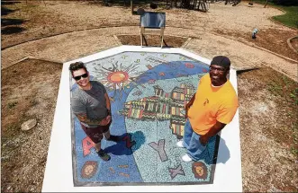  ?? LISA POWELL / STAFF ?? Jes McMillan (left) of the Mosaic Institute of Dayton and Dayton artist Charles “Boogie” Sweeney designed “Together We Rise,” a new play area and work of art in West Dayton. It is in a playground at Harvard Boulevard and Burroughs Drive on the Omega CDC Harvard Campus.