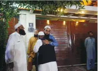  ?? (Reuters) ?? RELATIVES GATHER yesterday outside the residence of Junaid Jamshed, pop star turned evangelica­l Muslim cleric, in Karachi following news of his death in a plane crash.