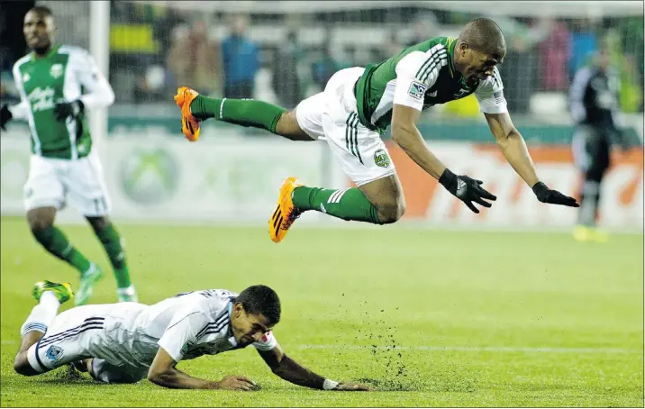  ?? CRAIG MITCHELLDY­ER/USA TODAY ?? Whitecaps defender Ethen Sampson fouls Timbers midfielder Darlington Nagbe during the second half of Saturday’s 1-1 draw in Portland, Ore.