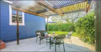  ??  ?? Enjoy the spacious patio with a pergola. The large yard includes lush foilage and citrus trees around the lawn.