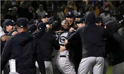  ?? Oakland Coliseum. Photograph: Thearon W Henderson/Getty Images ?? Yankees pitcher Domingo Germán is mobbed by his team-mates after throwing a perfect game on Wednesday night against the Athletics at