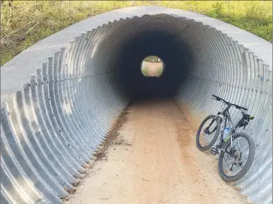  ?? NWA Democrat-Gazette photograph by Flip Putthoff ?? Halfway around Wolf Den Loop, bikers come to a tunnel under Arkansas 12. Keep going past the tunnel to complete the 4.2-mile loop.