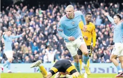  ?? PHOTOS BY AP ?? Manchester City’s Erling Haaland (centre) celebrates after scoring his side’s opening goal during the English Premier League match between Manchester City and Wolverhamp­ton at the Etihad Stadium in Manchester, England yesterday.