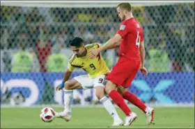  ?? RICARDO MAZALAN — THE ASSOCIATED PRESS ?? Colombia’s Radamel Falcao, left, vies for the ball with England’s Eric Dier during the round of 16 match between Colombia and England at the 2018 World Cup in the Spartak Stadium, in Moscow, Russia, Tuesday.
